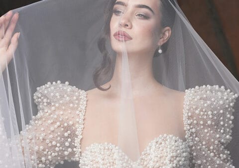 Bride wearing a cathedral-length wedding veil, perfect for a formal ceremony.