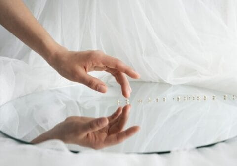 An artisan handcrafting a wedding veil with intricate details.